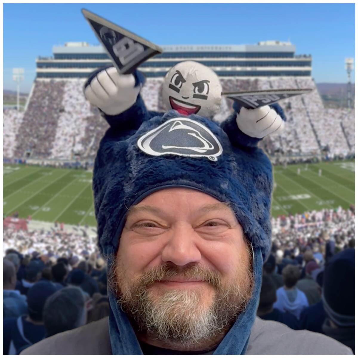 model wearing cheering sidekick hat with GO PSU flags in stadium setting